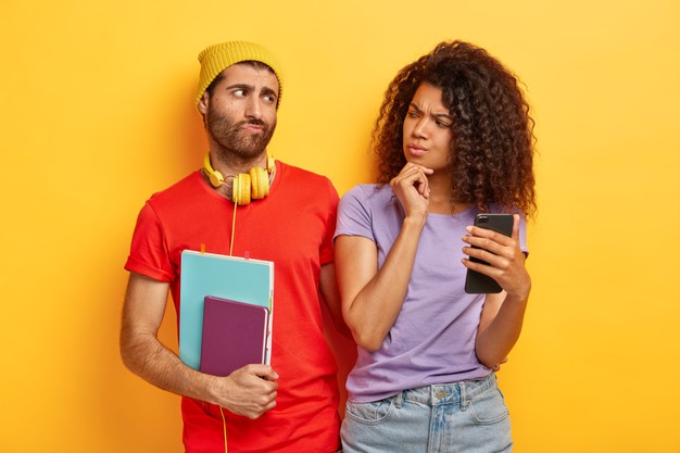 https://podoleanu-paun.ro/wp-content/uploads/2021/07/serious-afro-woman-holds-chin-uses-modern-smartphone-device-looks-suspiciously-boyfriend-checks-his-email-box-being-jealous-male-student-with-notepad_273609-27709.jpg